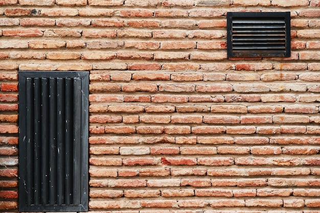 Brick dam wall with ventilation grilles advertising background or wallpaper screensaver