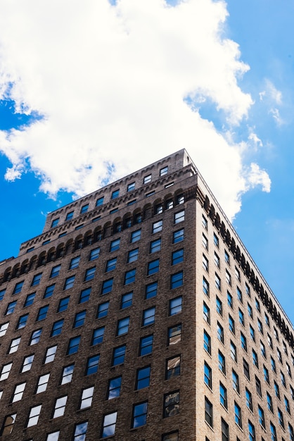 Brick high rise building angle from below cityscape