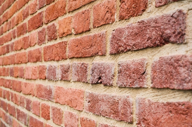 Brick wall lines of bricks going into the distance selective soft focus texture of natural red brick Grunge background or wallpaper idea with copy space