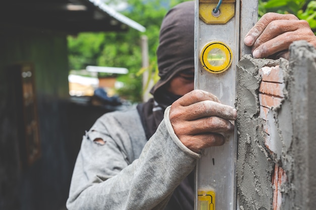 Bricklaying. construction worker building a brick wall.