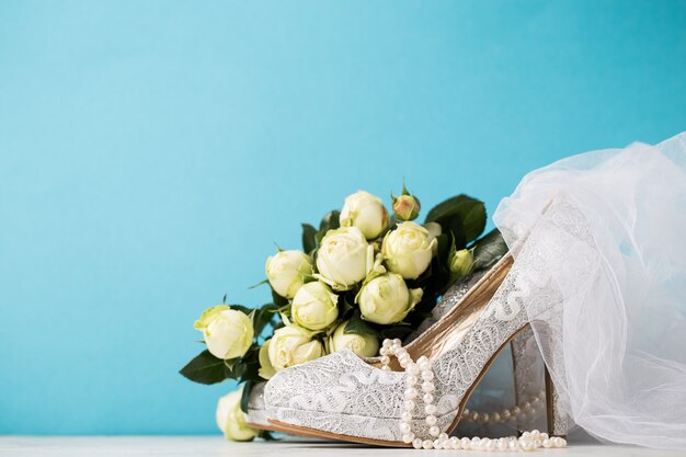 Bridal accessories composed together on blue