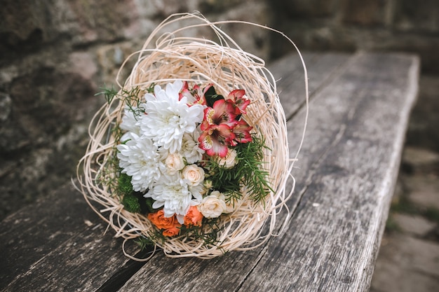 Free photo bridal bouquet on wooden bench