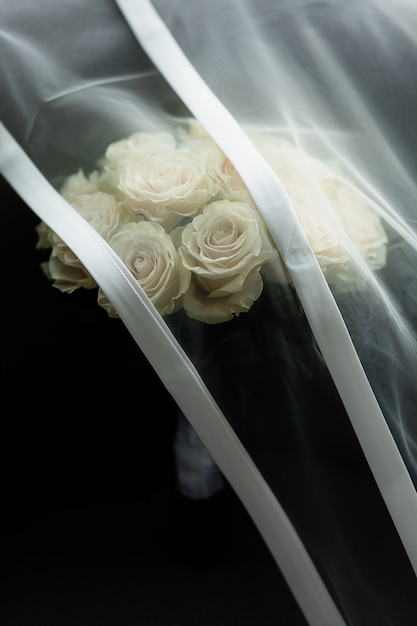 Free photo bridal veil covers up wedding roses bouquet