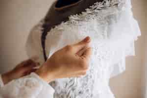 Free photo bride adjusts her bridal dress