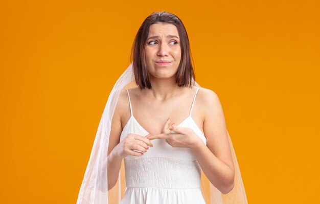 Bride in beautiful wedding dress looking aside confused and very anxious