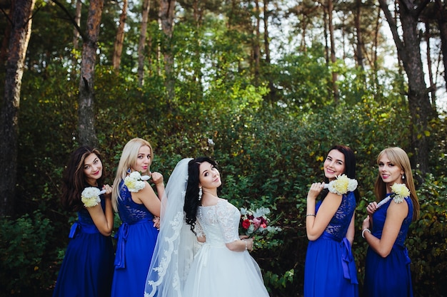 Bride and bridesmaid looking at camera smiling