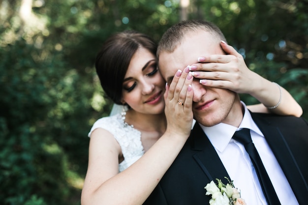 Bride covering the groom's eyes