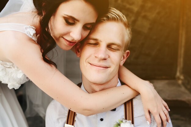 Bride embraces groom