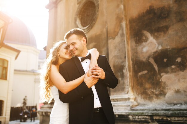 Bride embracing her boyfriend from behind