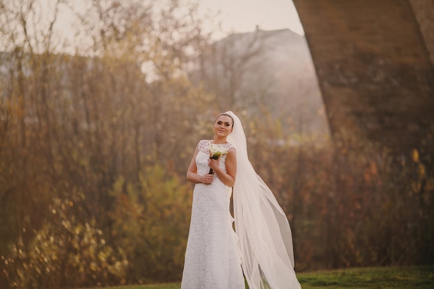 Bride in the forest with a bouquet