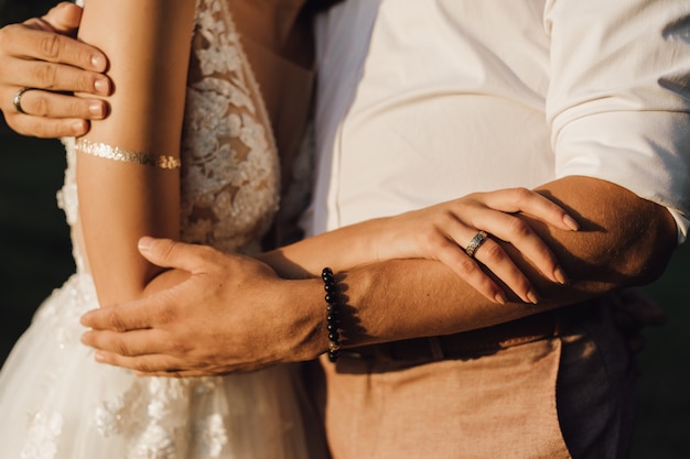 Bride and groom are hugging, without face