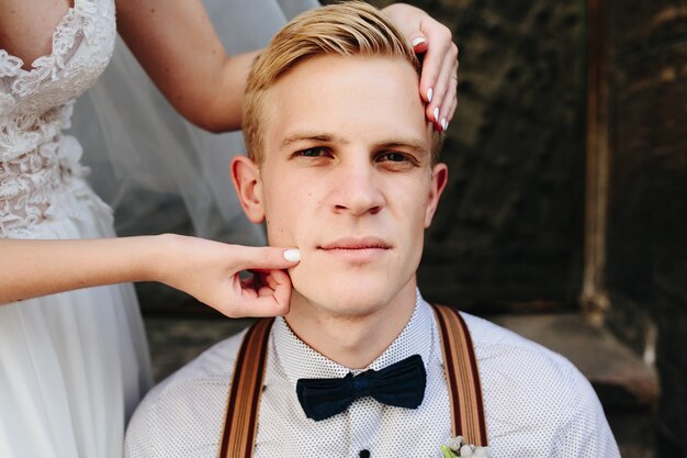 Bride groom cheek pinching