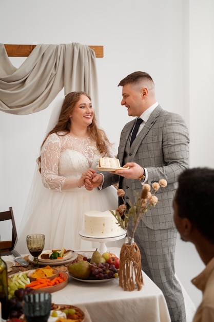 Bride and groom cutting the cake at their wedding