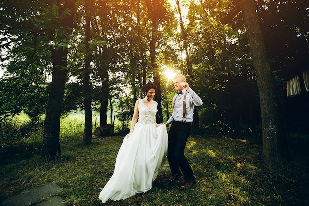 Bride and groom dancing in nature, somewhere in the forest