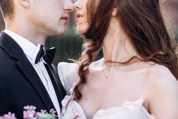 The bride and groom embracing in the park