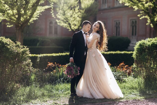 The bride and groom embracing in the park