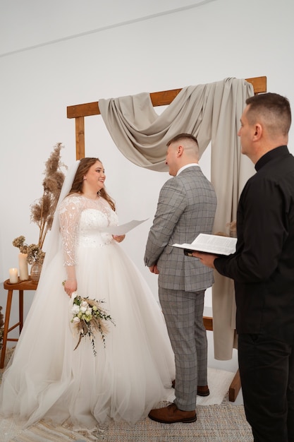 Free photo bride and groom exchanging vows at the wedding ceremony