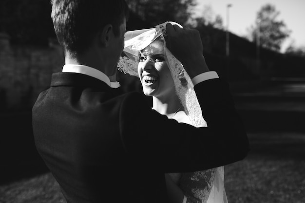 Free photo bride and groom having fun in an old town