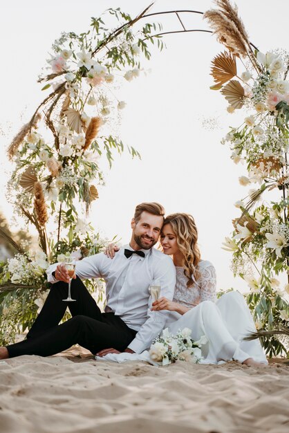 Bride and groom having their wedding at the beach