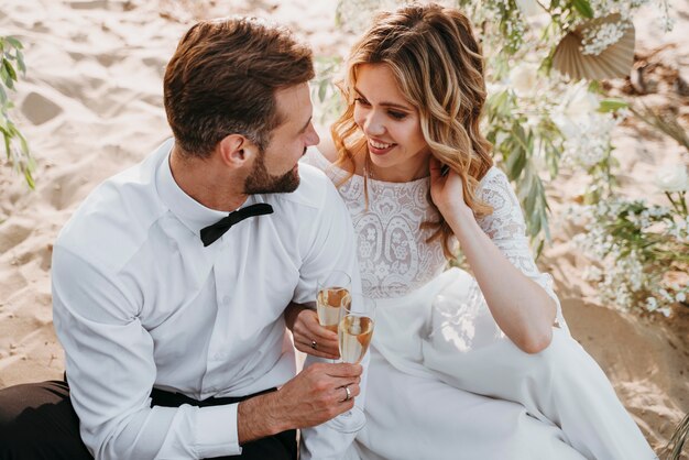 Bride and groom having their wedding at the beach