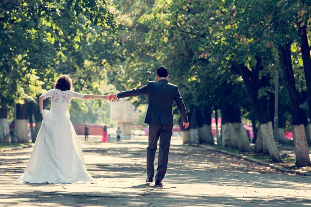 Bride and groom holding hands