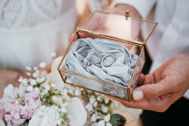 Bride and groom holding their rings