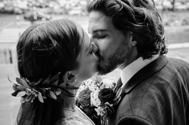 Bride and groom kissing outside the church