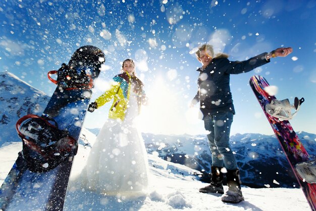 Bride and groom in love throw snow background of the Alps Courchevel