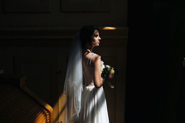 Bride and groom posing in the dimly lit room