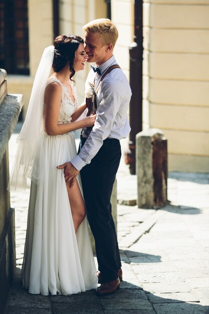 The bride and groom posing in the old street