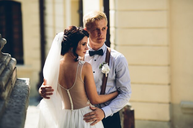 The bride and groom posing in the old street