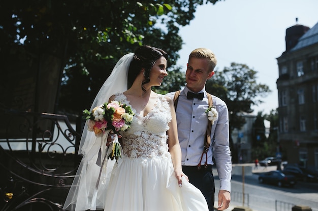 Free photo bride and groom posing on the streets of the old town