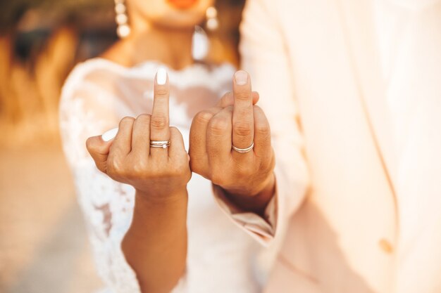 bride and groom showing their rings