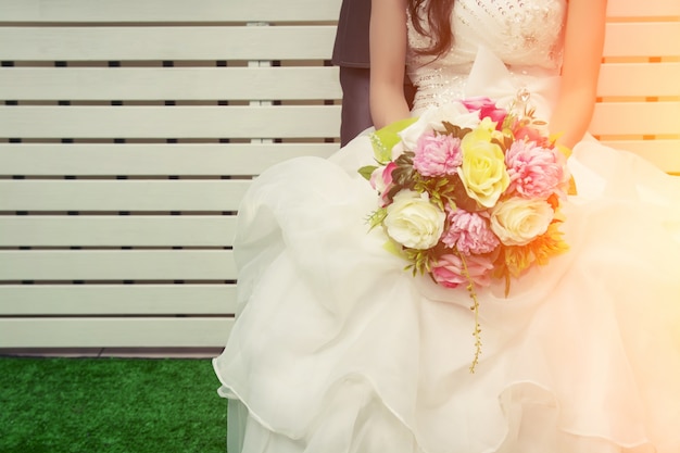 Free photo bride holding a colorful bouquet