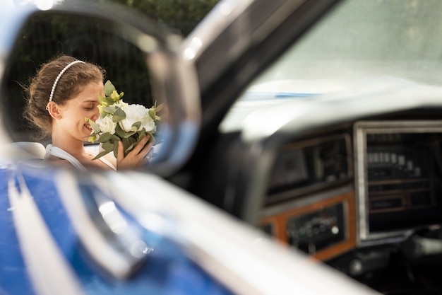 Bride holding flowers side view