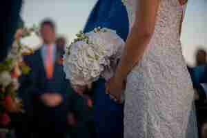 Free photo bride holding wedding bouquet standing