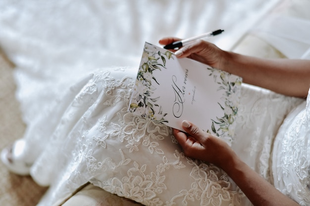 Bride is writing the wedding vows , wedding day symbols