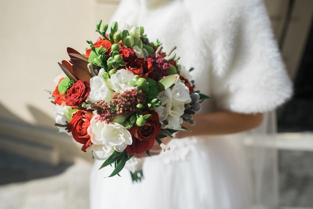 The bride keeps a wedding bouquet