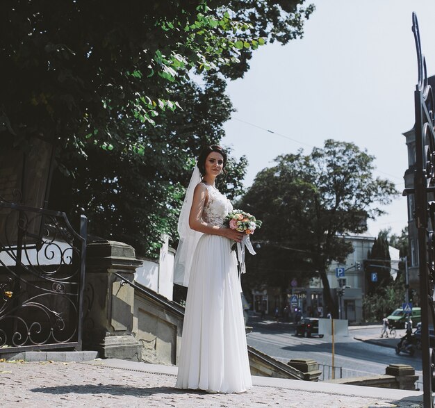 Bride posing on the background of the old town