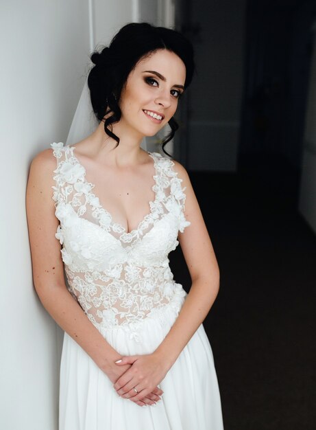 Bride posing in a corridor on the camera