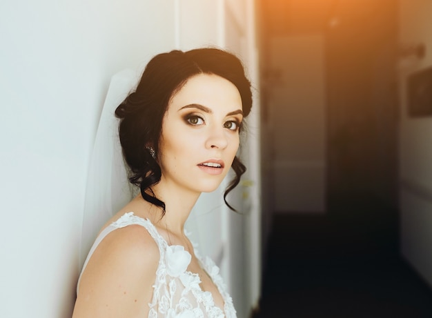 Bride posing in a corridor on the camera