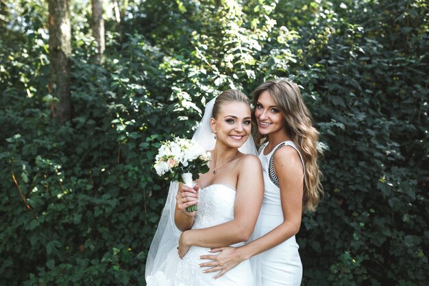 Bride posing with bridesmaid