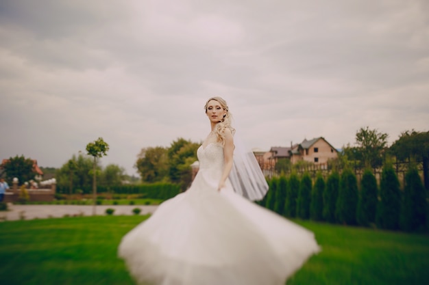 Bride posing with her dress outdoors