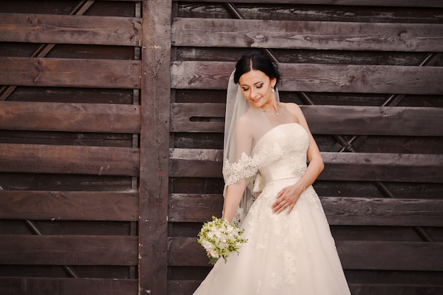 Bride posing with wedding dress