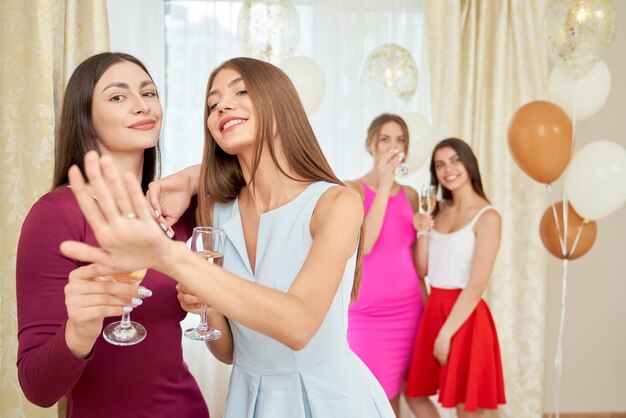 Bride showing engagement ring on hand