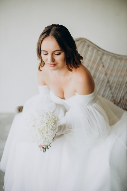 Bride sitting in chair on her wedding day