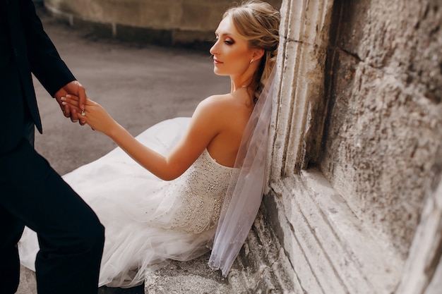Bride sitting on a stone bench