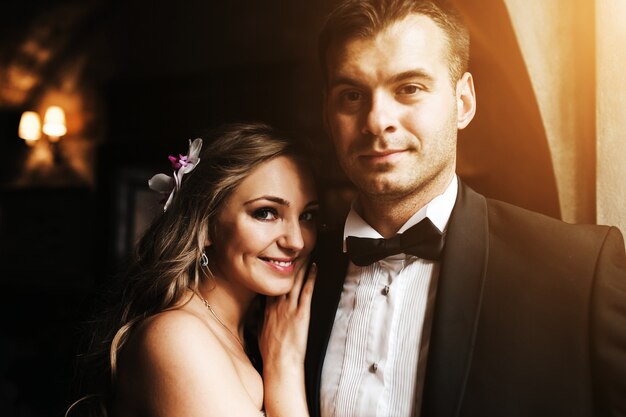 Bride smiling leaning on her boyfriend's chest