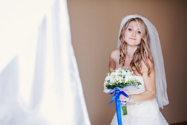 Bride smiling with bouquet