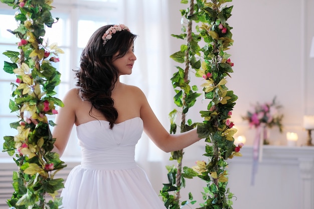 Free photo bride on a swing with flowers